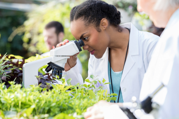 Girl looking through microscope