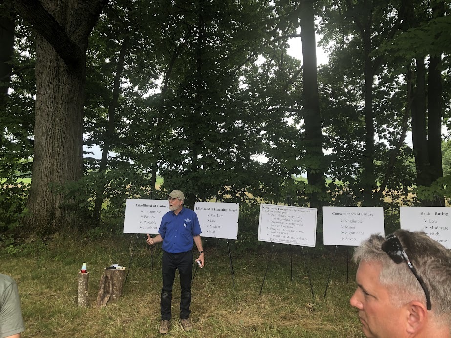 Man talking in front of signs