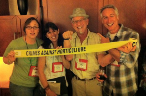 4 people with tape that says "Crimes Against Horticulture"